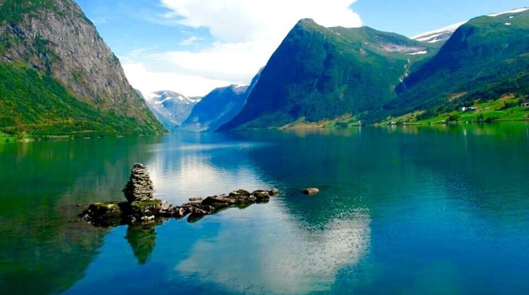 Stunning views through the fiords of Norway. Near Bergen where in summer time the green land and the white snow make a gorgeous combination.