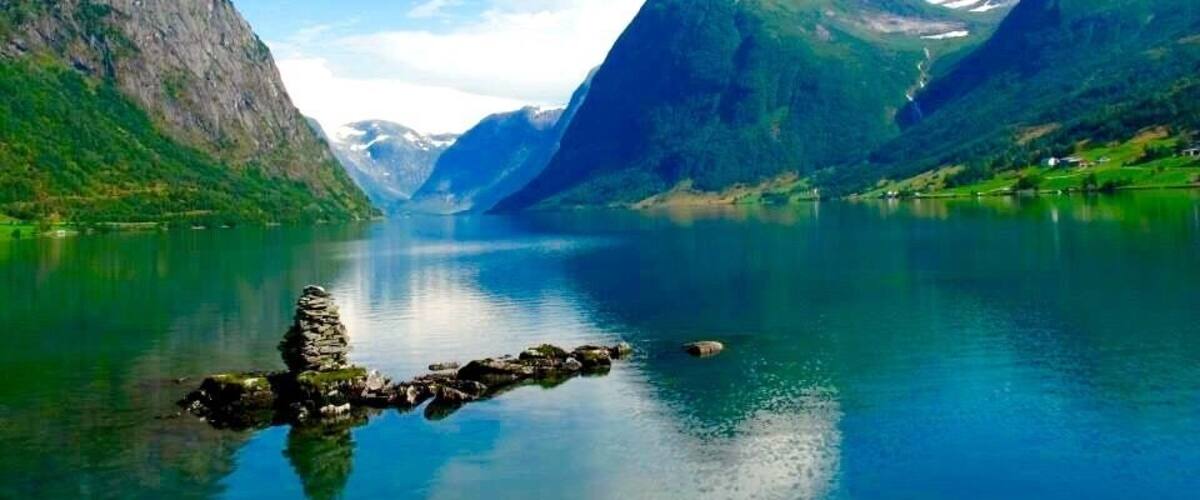 Stunning views through the fiords of Norway. Near Bergen where in summer time the green land and the white snow make a gorgeous combination.