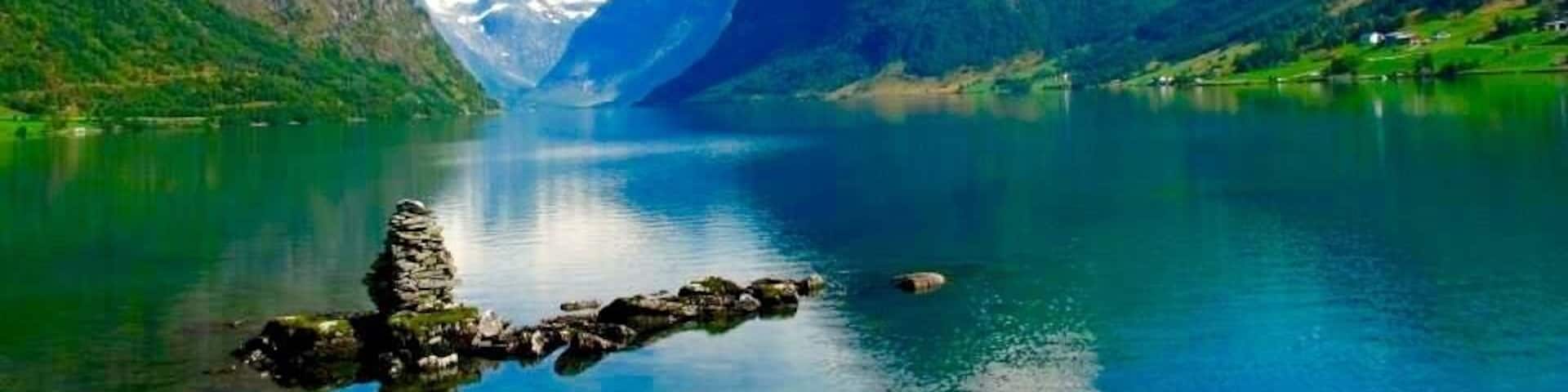 Stunning views through the fiords of Norway. Near Bergen where in summer time the green land and the white snow make a gorgeous combination.