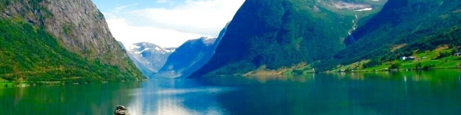 Stunning views through the fiords of Norway. Near Bergen where in summer time the green land and the white snow make a gorgeous combination.