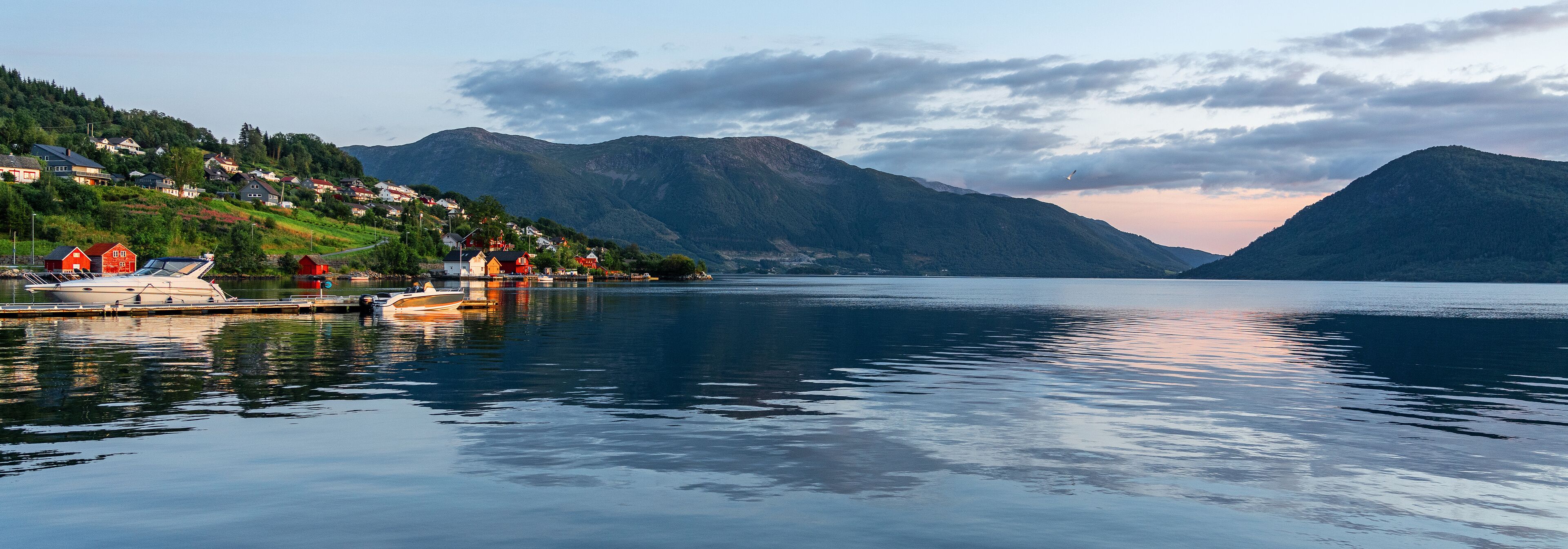 Norwegian fjords rural landscape, Norway, mountain sea view, Rosendal village houses on green hill.