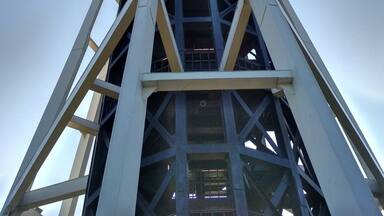 A tall tower with a circular observation deck at the top.
