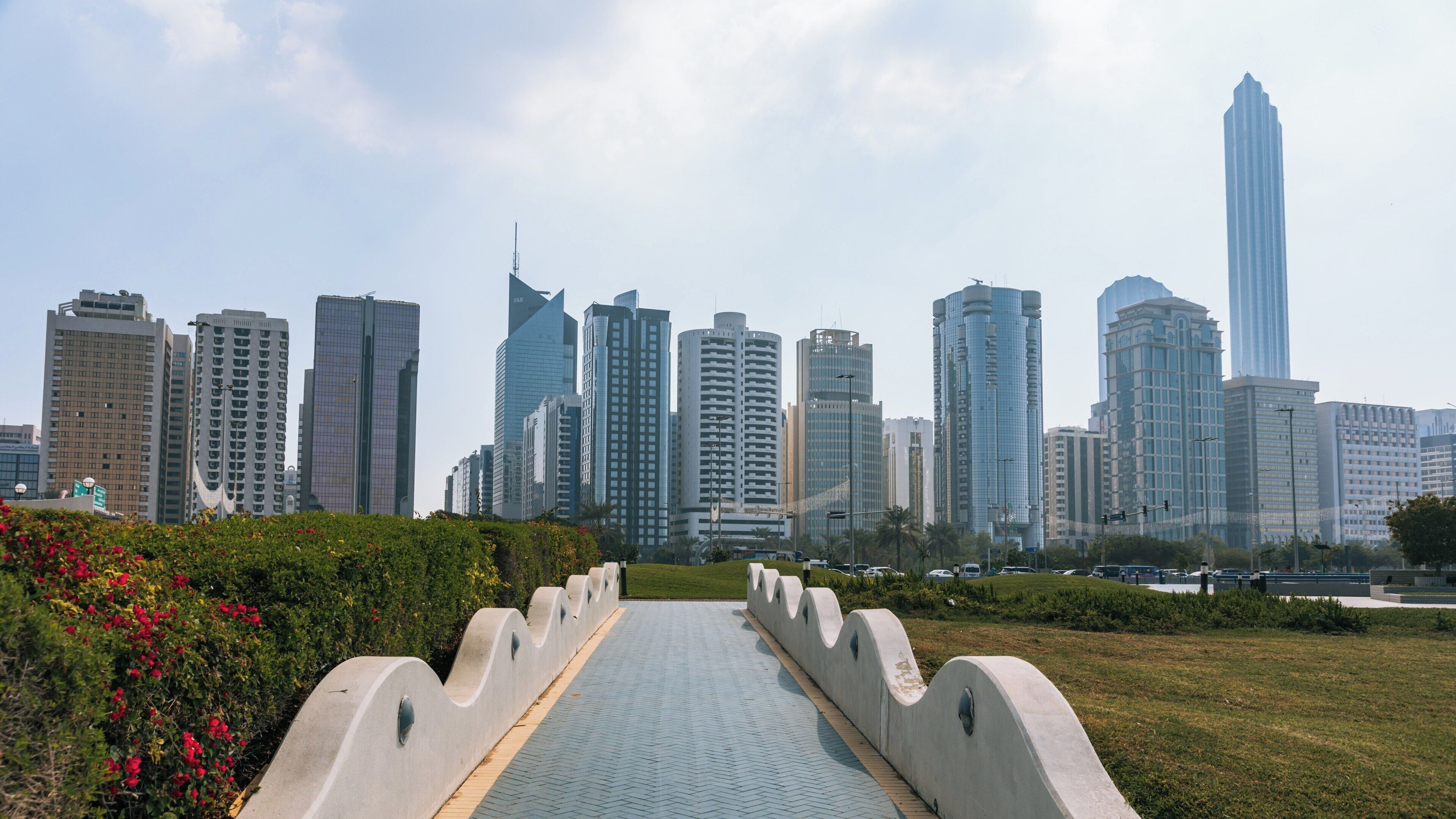 Stunning skyline view of Abu Dhabi Corniche featuring modern architecture and lush greenery in Al Zahiyah district during the day
