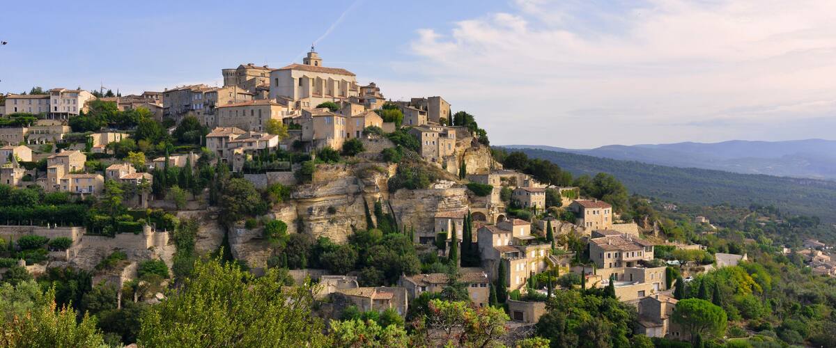 A historic town built on a hillside with traditional architecture and a prominent church.