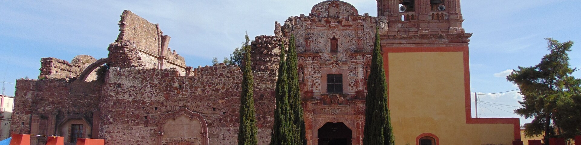 A historic church with a bell tower and a large dome.
