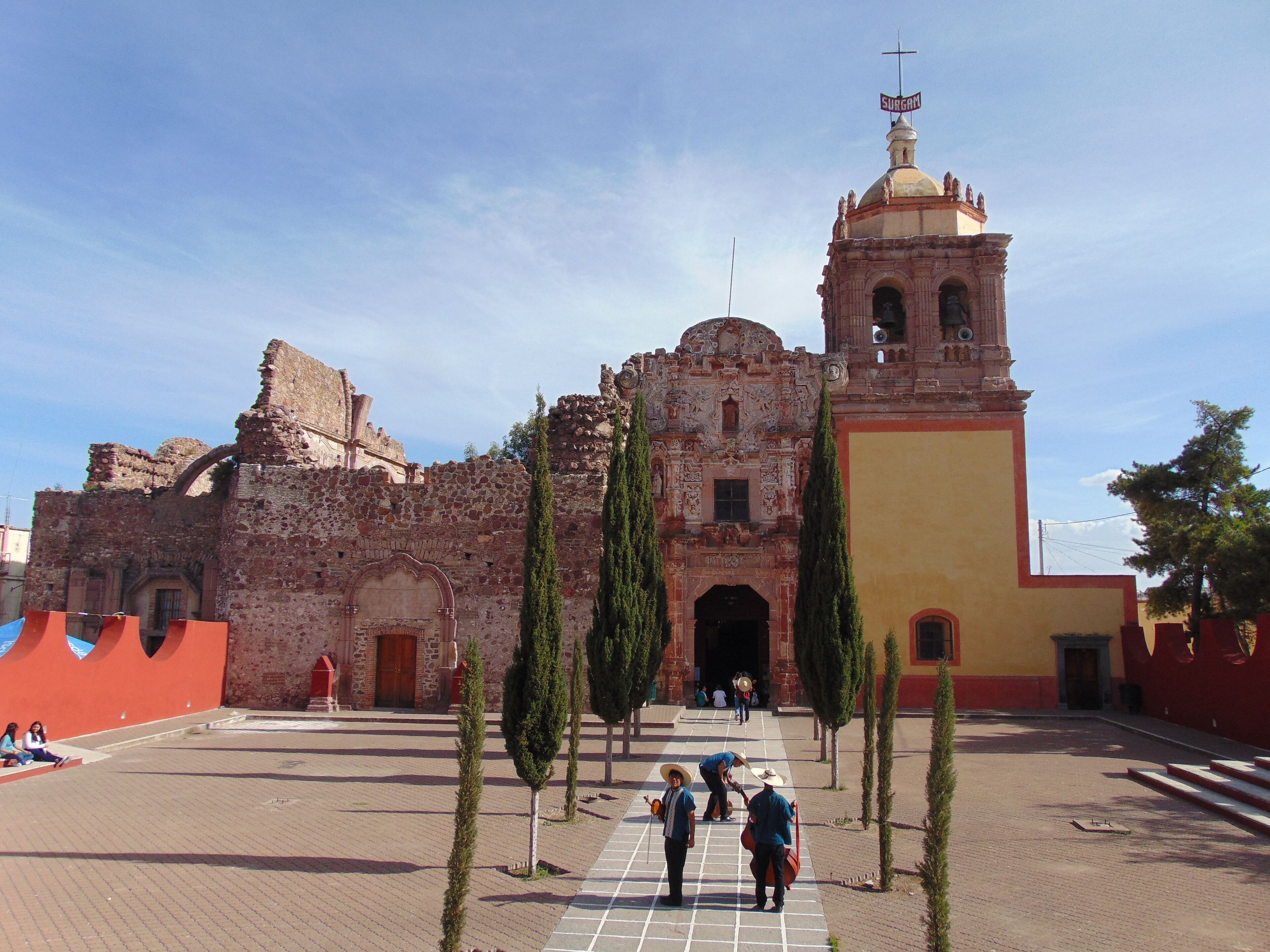 A historic church with a bell tower and a large dome.