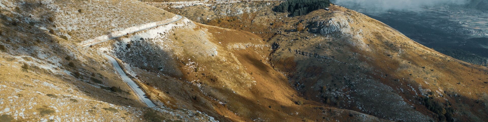 Aerial view of Pangaio mountain landscape with road and thick clouds at daytime.