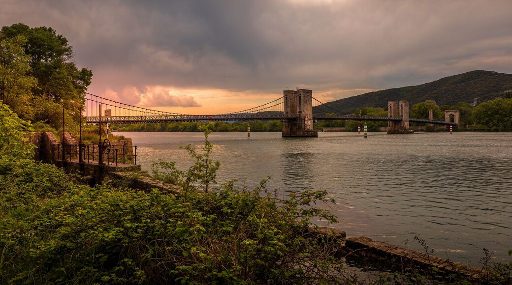 View of the Pont du Robinet bridge with a cloudy sky highlighting its metallic structure, Donzère, France