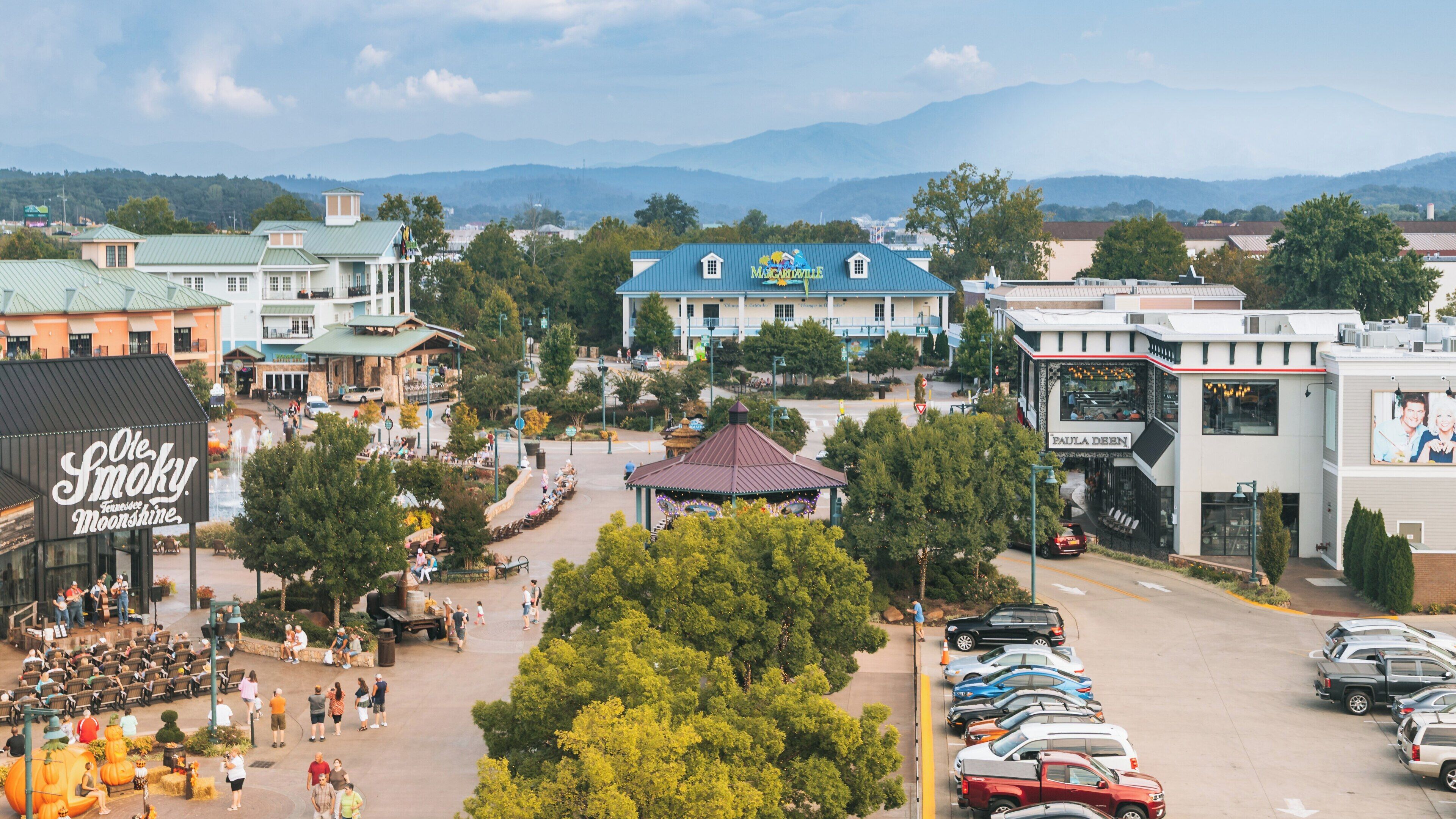 Experience the Great Smoky Mountain Wheel in Downtown Pigeon Forge, Tennessee, on a lively day filled with visitors and scenic views