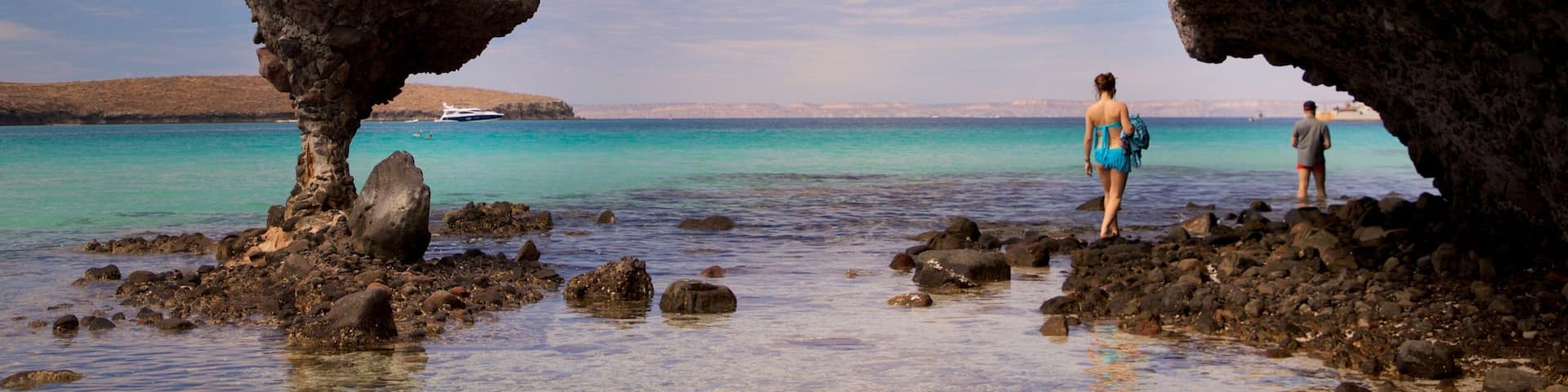 Balandra Beach which includes rugged coastline and general coastal views as well as a couple