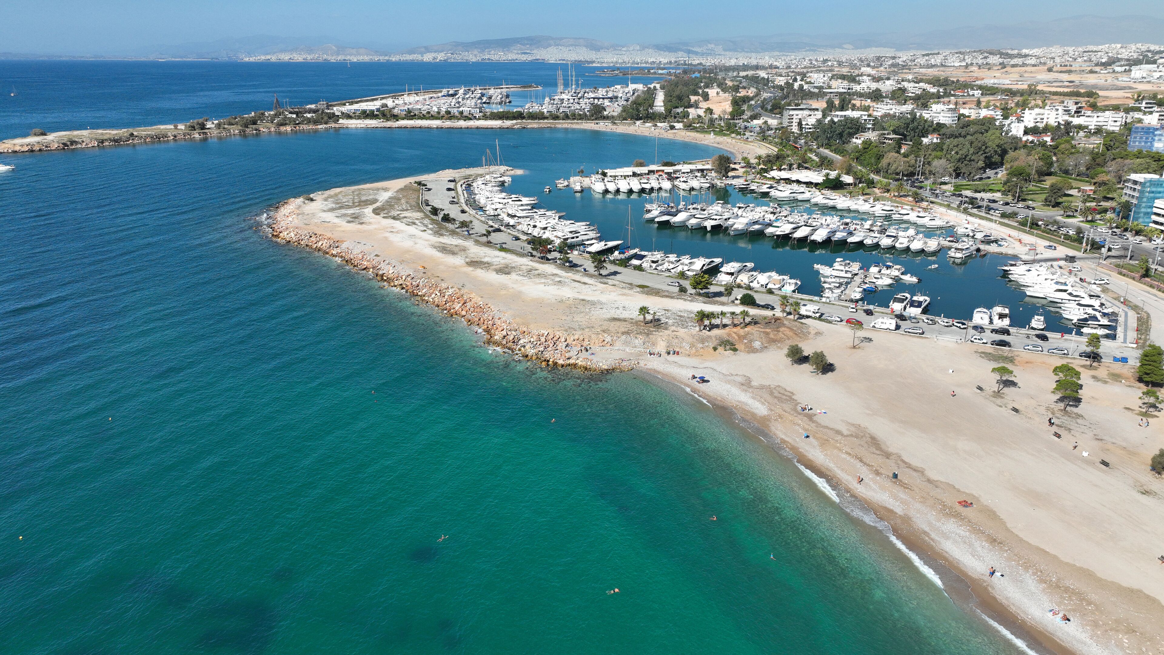 Aerial drone photo of seaside touristic area with paradise beaches and modern architecture of Glifada, Athens riviera, Attica, Greece