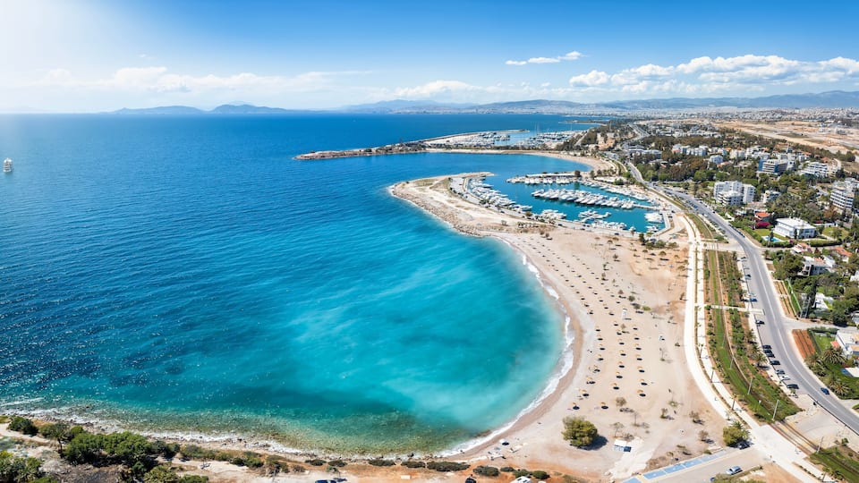 A coastal city with a marina, beach, and urban area.
