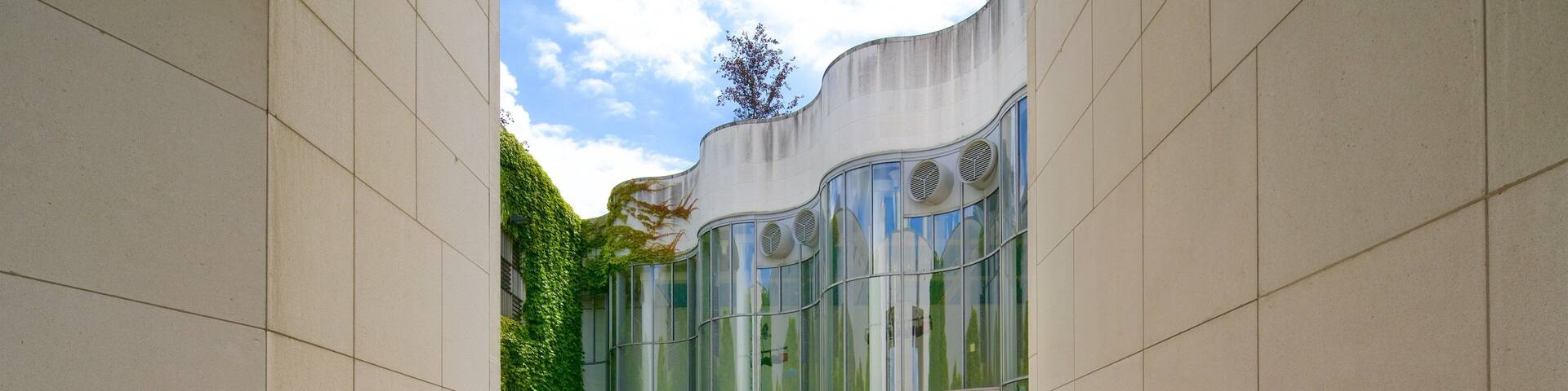 A modern building with a curved facade and large windows.