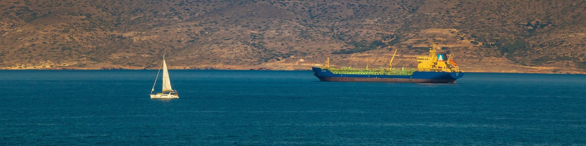 A yatch and a tanker in front of Kea Island