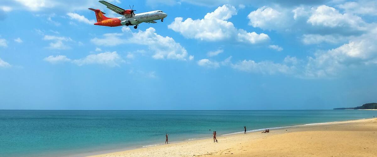 Phuket International Airport runway starts/ends right on Mai Khao beachfront. It offers a very popular photo opp spot. Planes pass right above one's head when landing. This spot is so popular that several snacks and drinks stalls settle everyday under the shade of the trees right next to it. #LifeAtExpedia