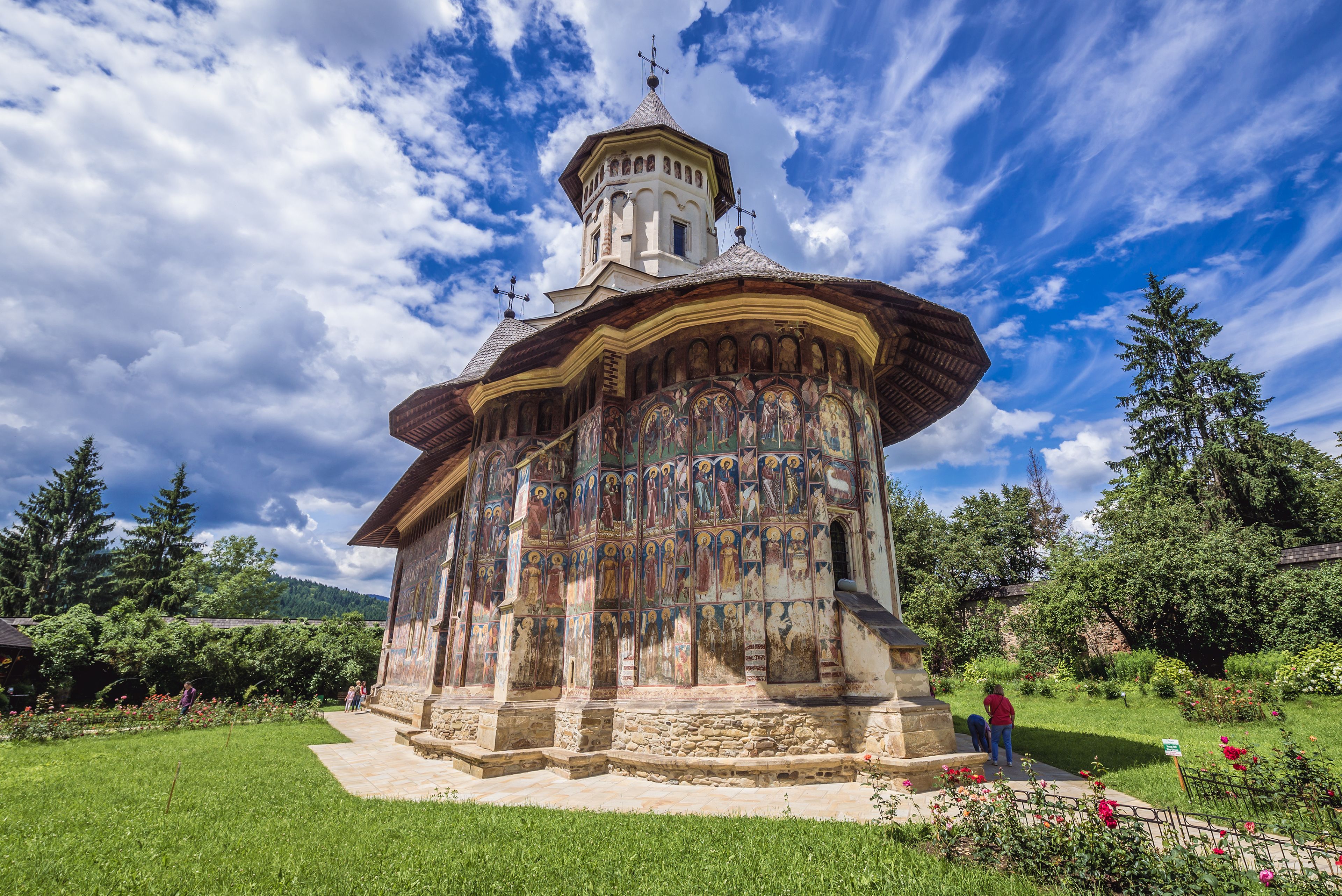 A historic church with a bell tower and a colorful iconostasis.
