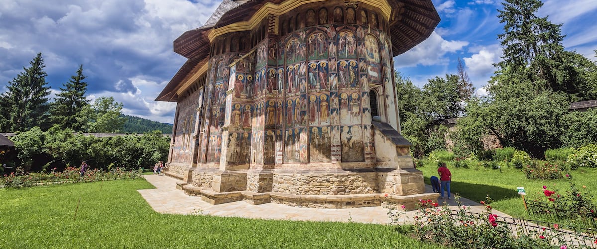 A historic church with a bell tower and a colorful iconostasis.