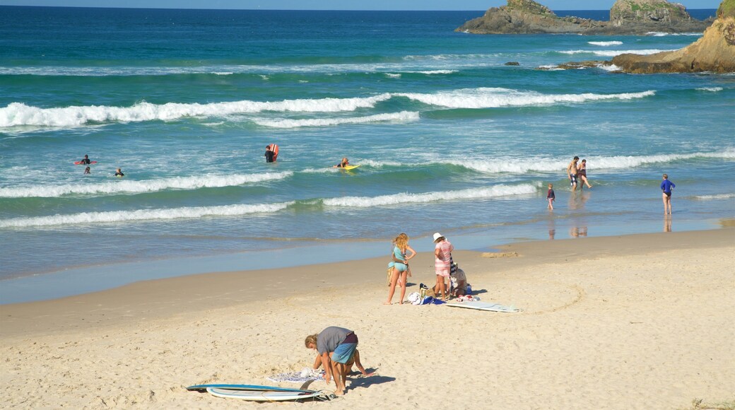 Broken Head which includes a sandy beach as well as a large group of people