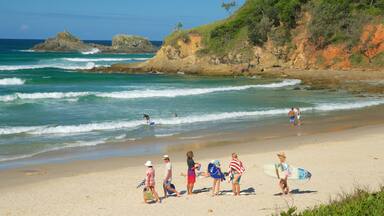Broken Head featuring a sandy beach as well as a family