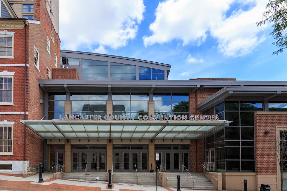 The Lancaster County Convention Center with a modern glass facade and a brick exterior.