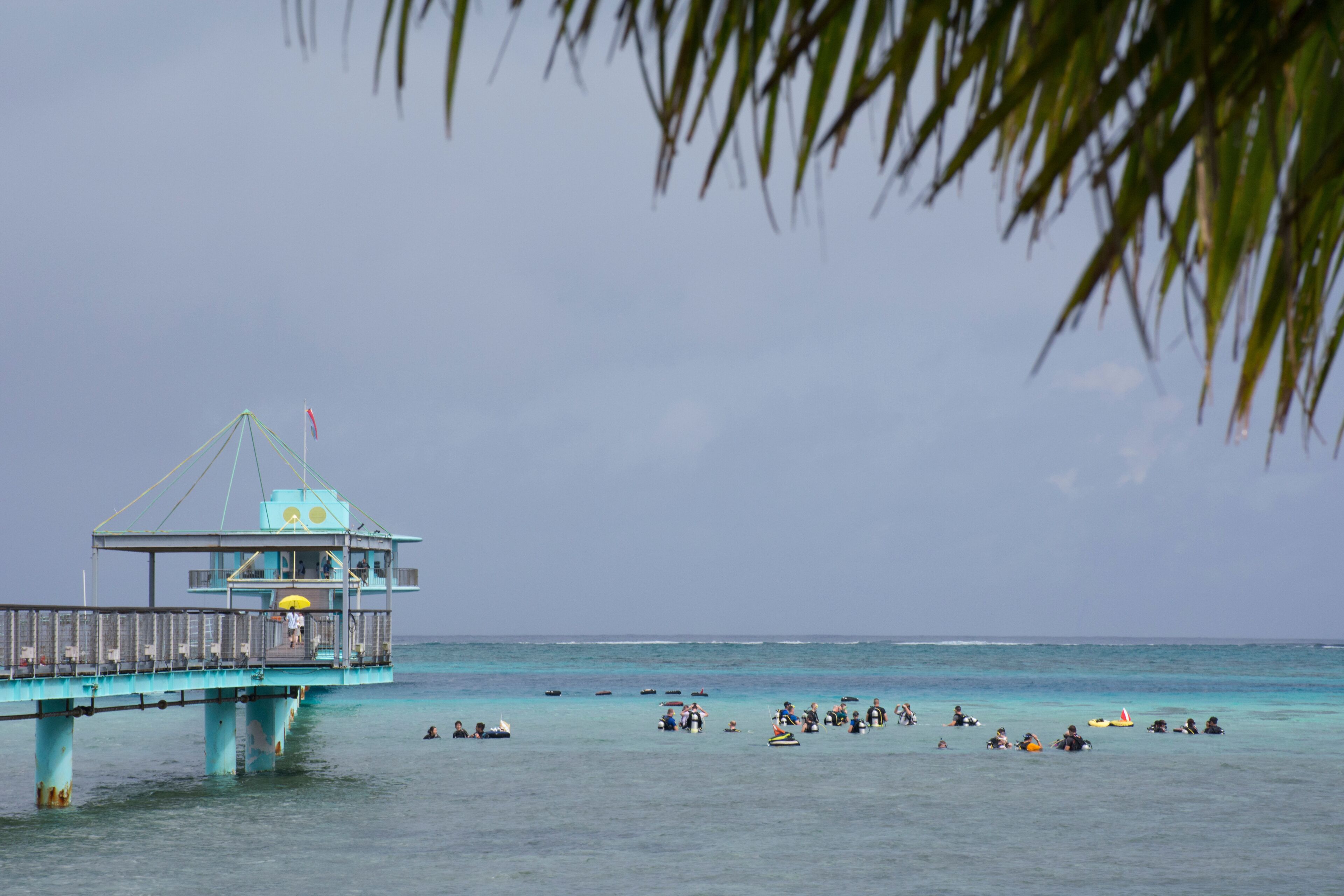Micronesia, Mariana Islands, US Territory of Guam. Fish Eye Marine Park located on the Philippine Sea. Long pier with scuba diving students.