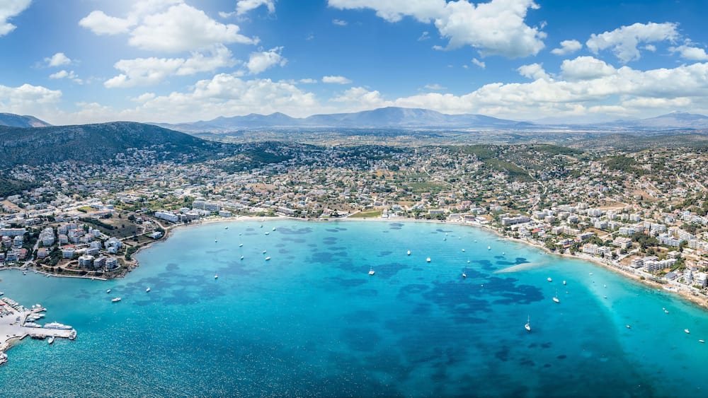 Wide panoramic aerial view of the town and bay of Porto Rafti, popular destination for Athenians during summer time, Attica, Greece