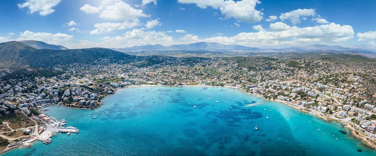 Wide panoramic aerial view of the town and bay of Porto Rafti, popular destination for Athenians during summer time, Attica, Greece