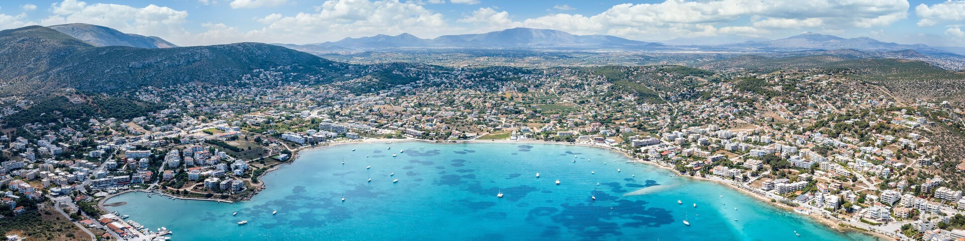 Wide panoramic aerial view of the town and bay of Porto Rafti, popular destination for Athenians during summer time, Attica, Greece