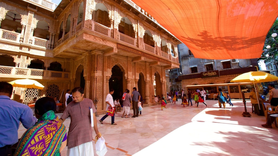 ISKCON Temple featuring a temple or place of worship as well as a small group of people