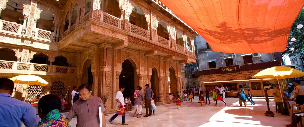 A historic building with intricate carvings and a large orange canopy.