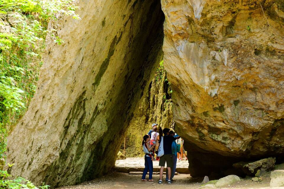 A large rock formation with a narrow passageway.