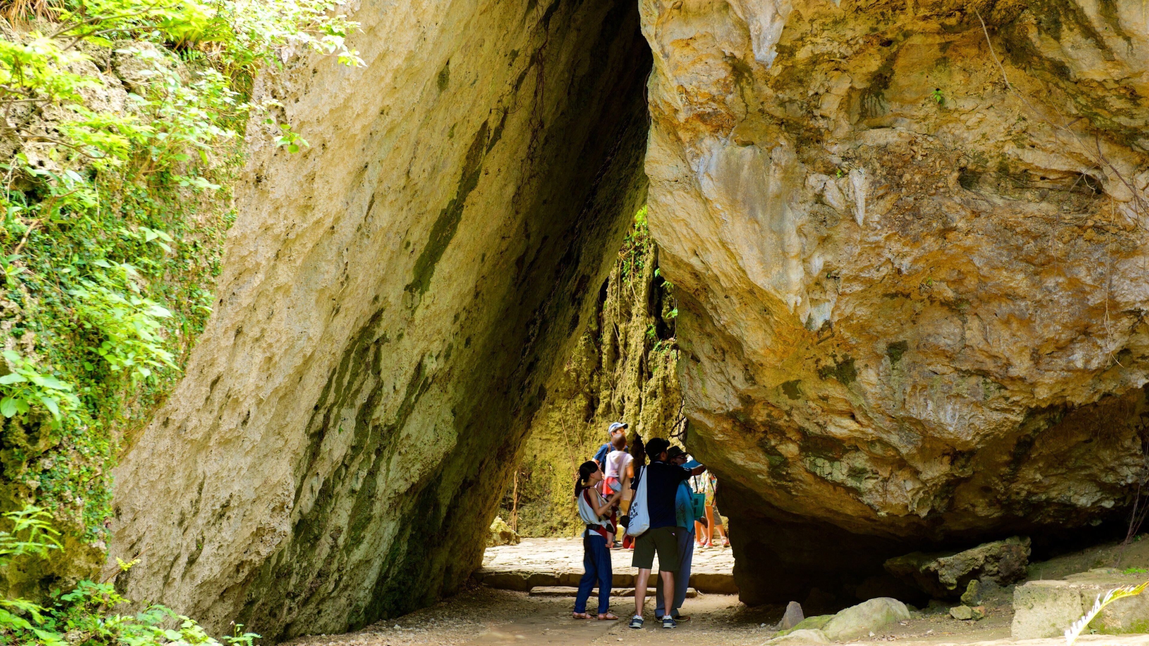A large rock formation with a narrow passageway.