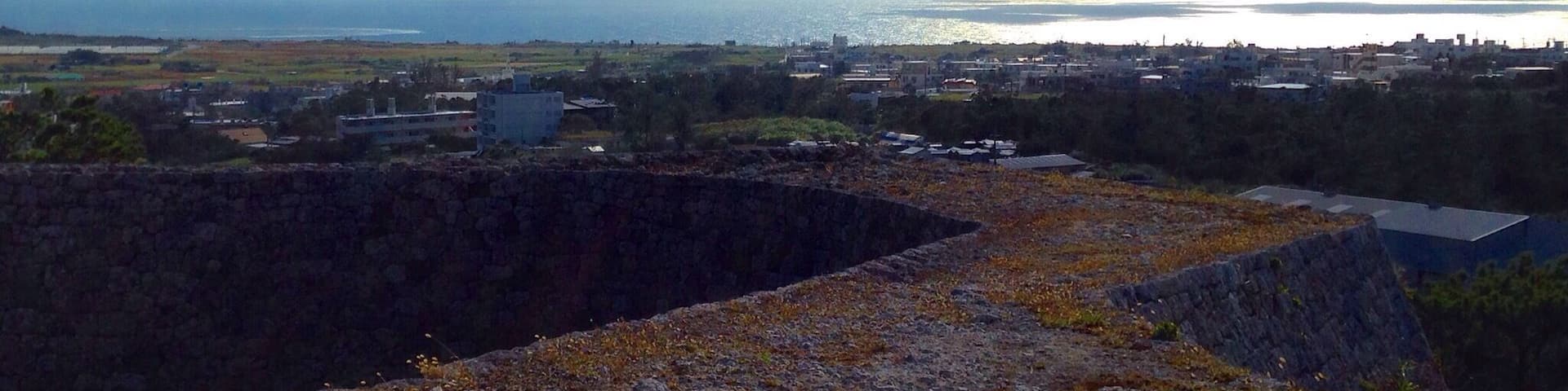 These castle ruins give a great vantage point over looking Yomitan. There is a small park of paths and pine trees around the base and beautiful grass to sit and relax inside.
