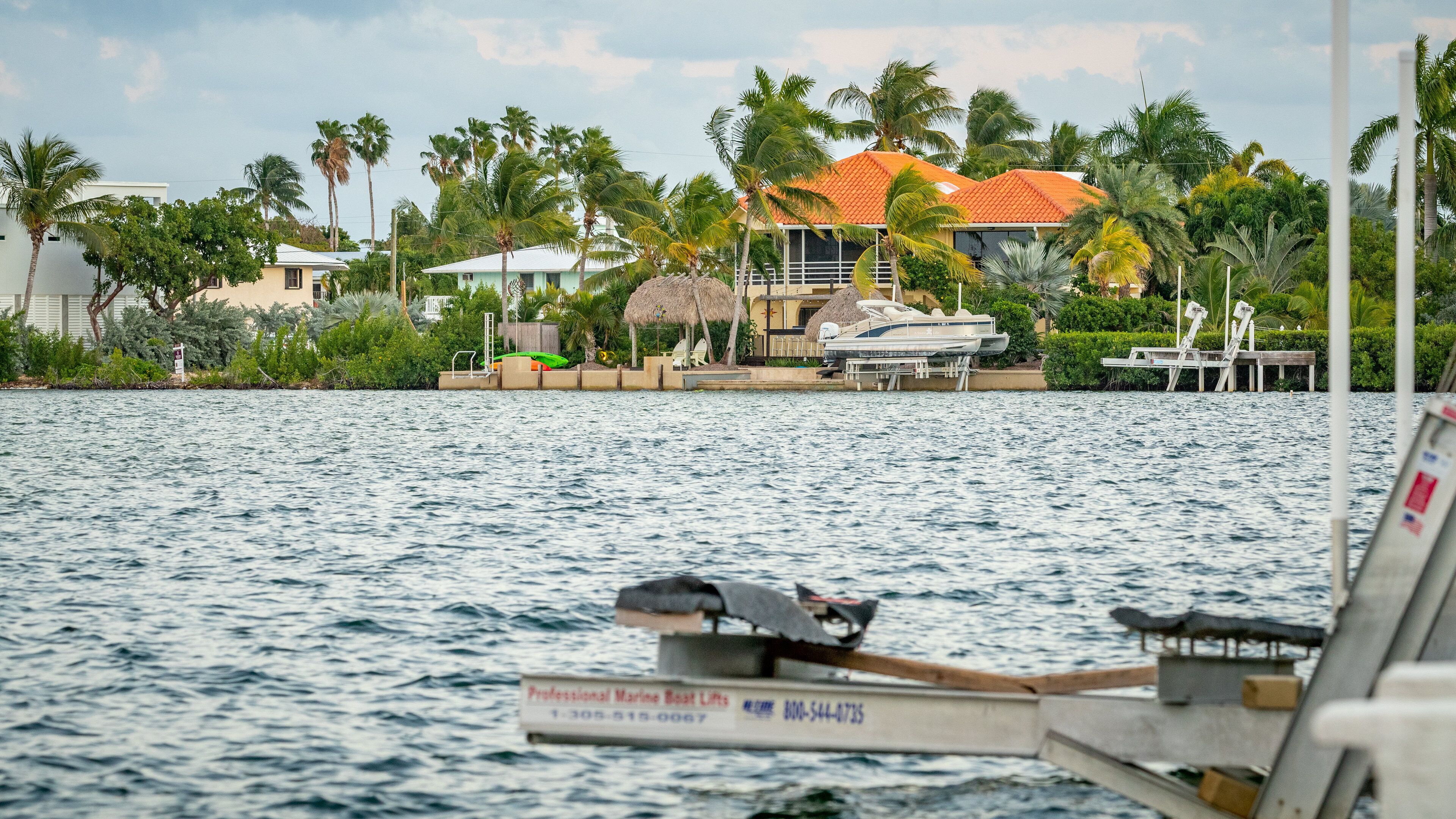 Sugarloaf Shores which includes a bay or harbor and a house