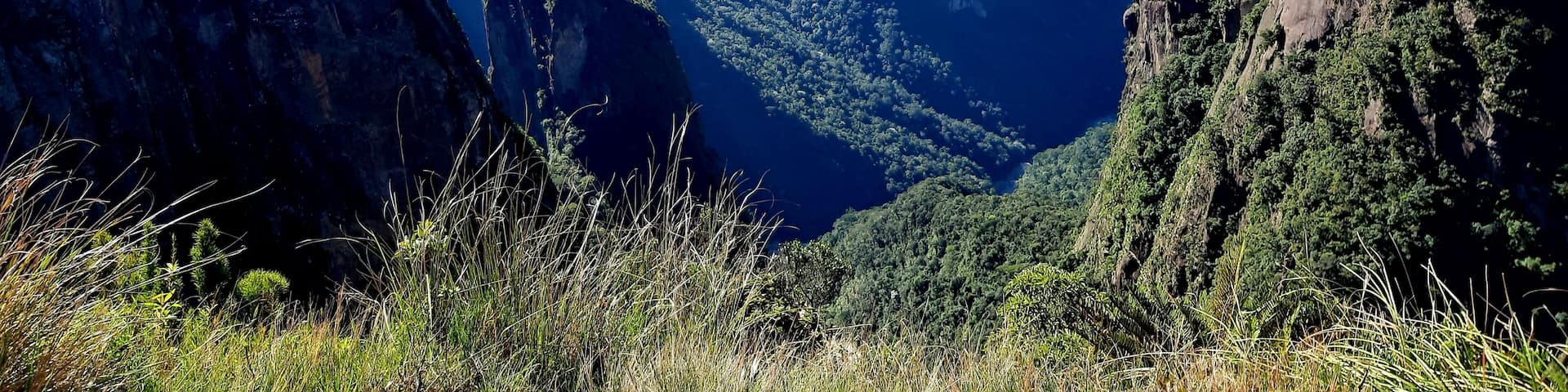 A mountainous landscape with prominent peaks and lush greenery.