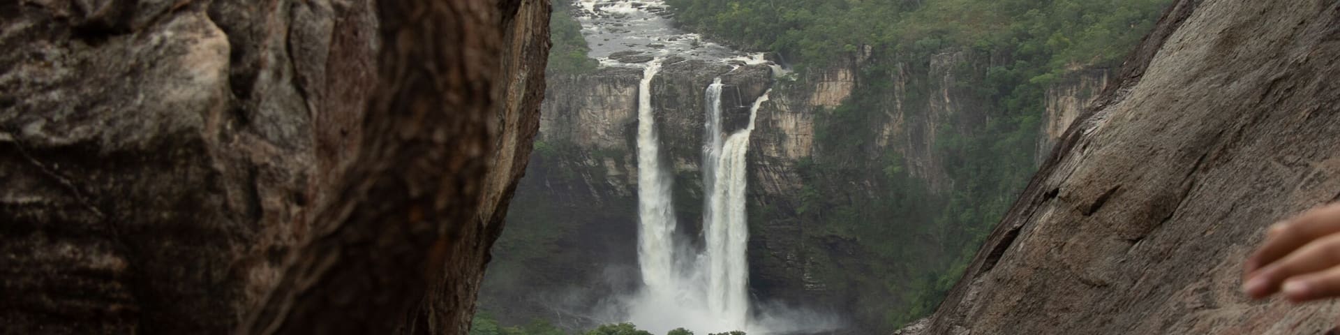 A waterfall cascading down a cliff surrounded by rugged rock formations.