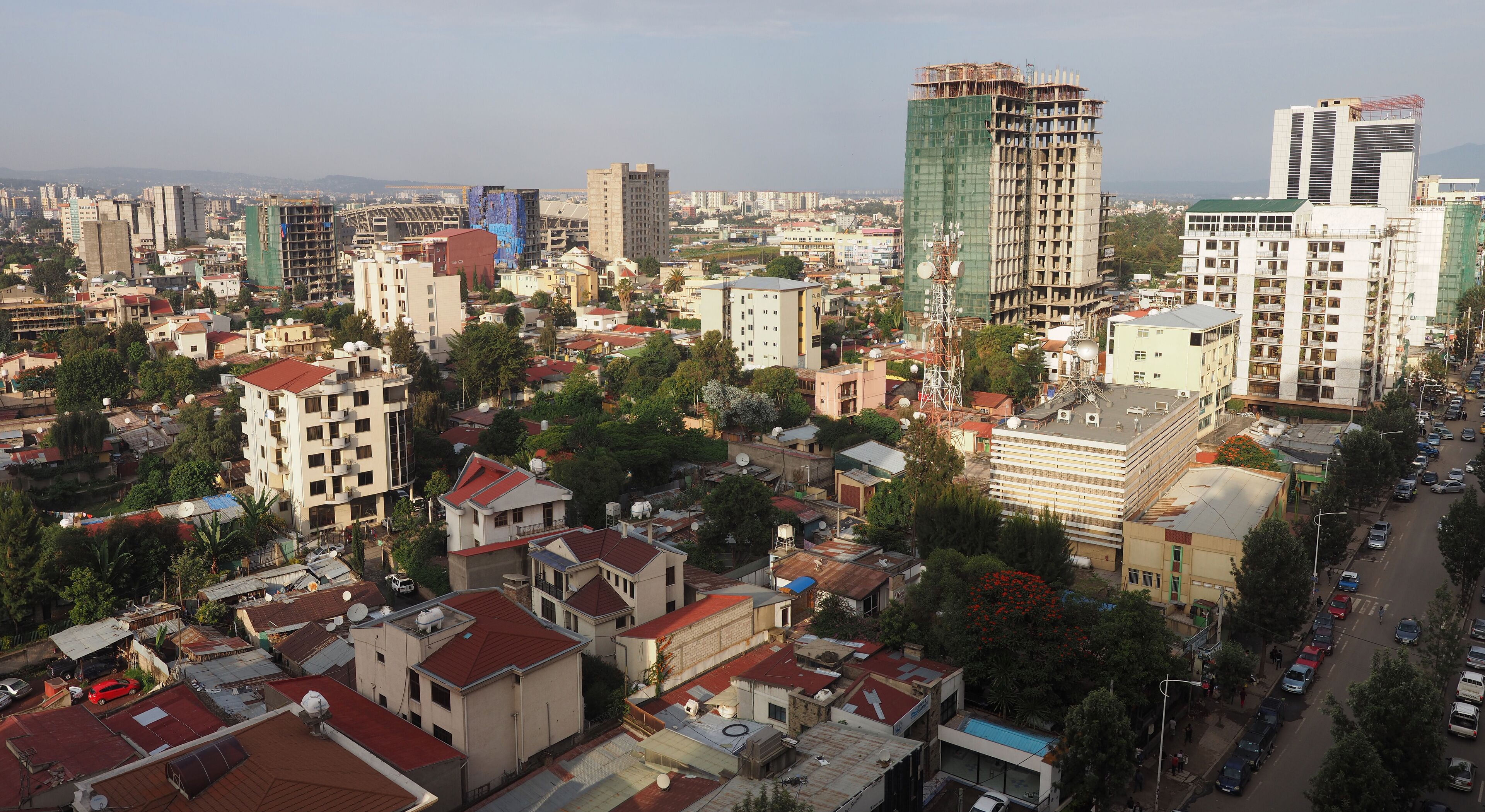 A cityscape with various buildings, including high-rises and smaller structures, under construction.