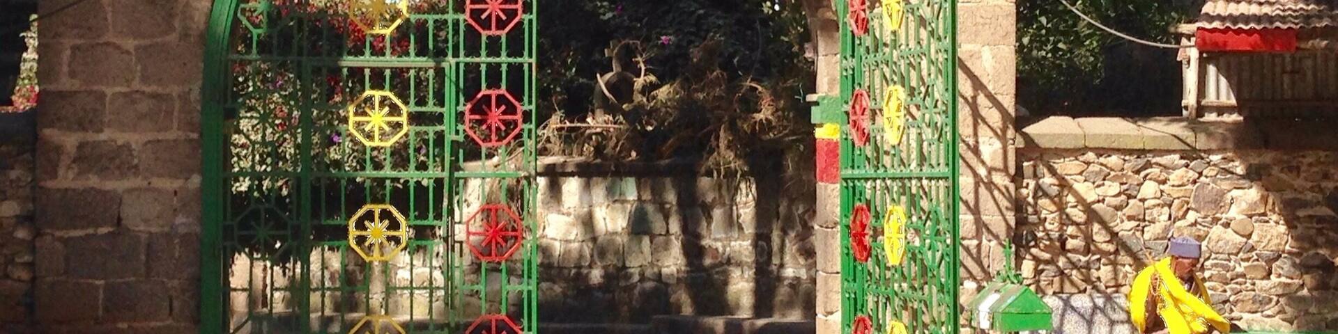 Holy Trinity Church is a well known sight in Addis Ababa and arguably one the most important churches in Ethiopia.
You can entered the church and pictures are allowed but you'll need to leave your shoes at the door. The middle door is considered the men's entrance and the one to the far right the woman's.
Don't forget to take a walk behind the church to see the site of the old round church and this colorful gate.