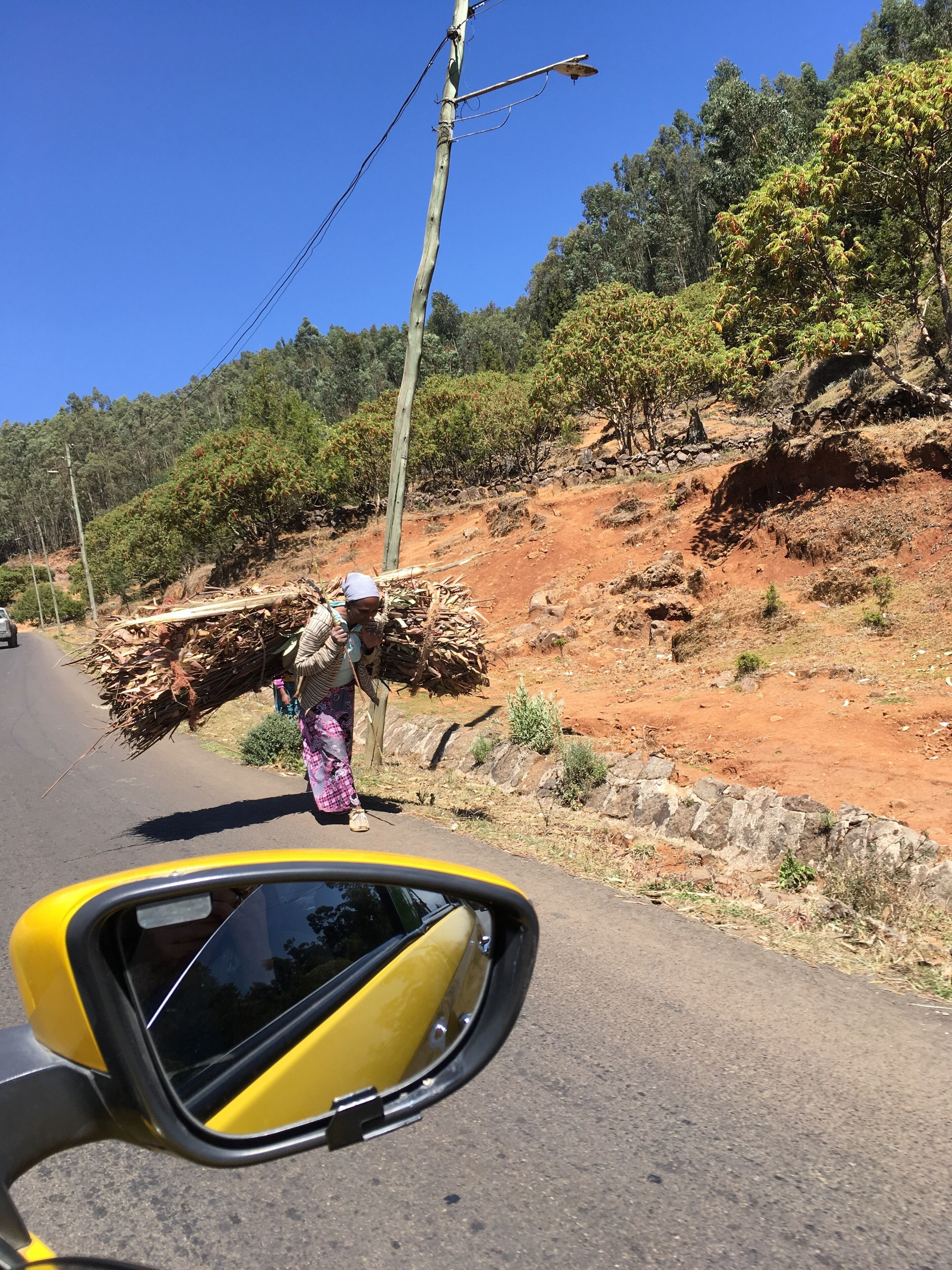 I was driving up the steep hill just out of Addis Ababa, Ethiopia to visit the Christian churches at the top. There were many women bowed over by their heavy loads of sticks going down to sell their wood. One of the many reminders of how tough life can be for many women around the world. #ontheroad