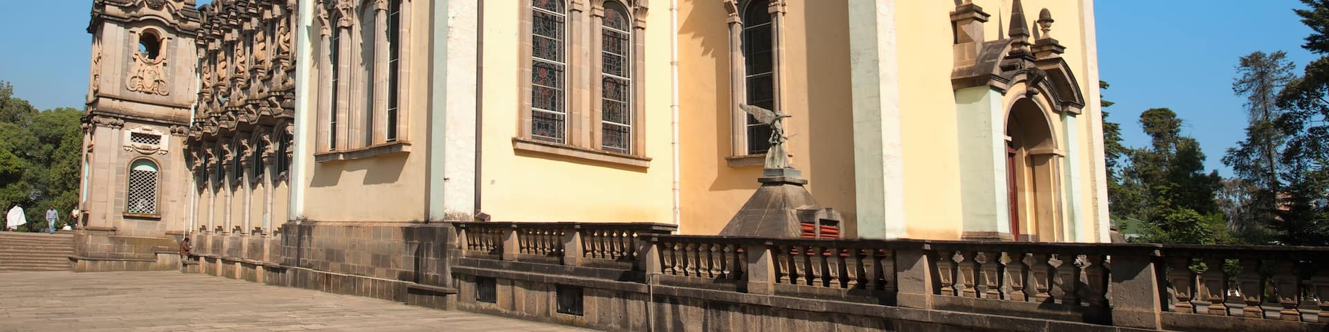 A historic church with a large dome, ornate columns, and a bell tower.