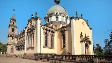 A historic church with a large dome, ornate columns, and a bell tower.