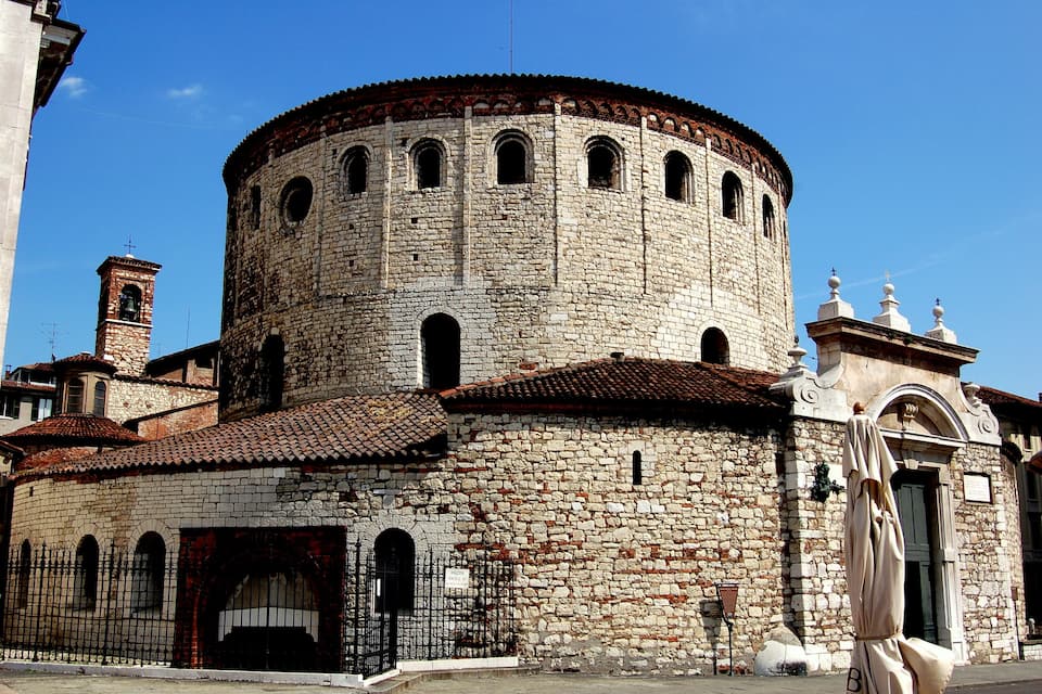 A historic stone tower with arched windows and a tiled roof.