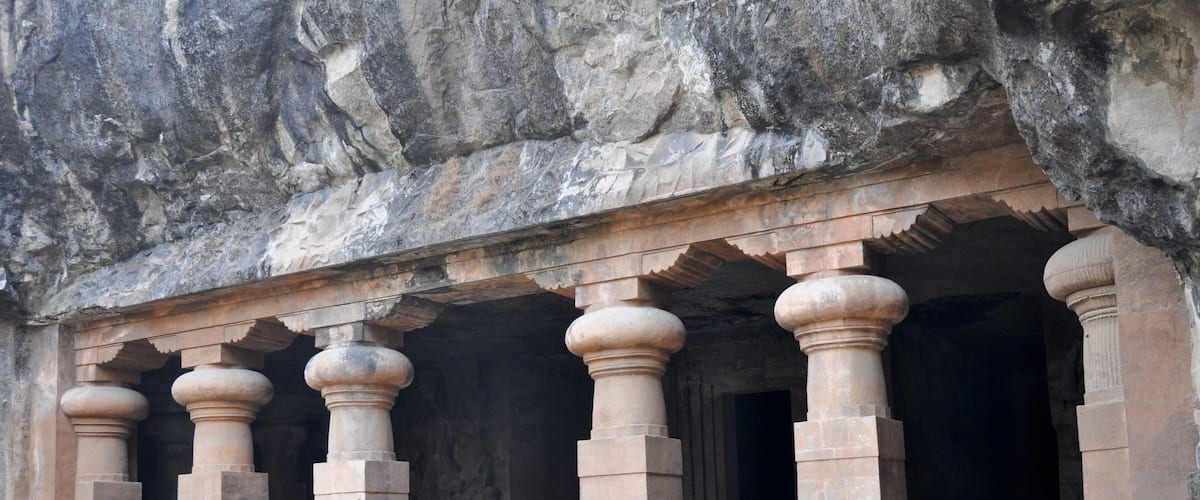 A stone structure with carved pillars and steps.