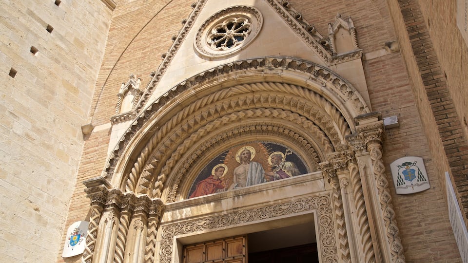 A Gothic-style church facade with intricate stone carvings and a rose window.