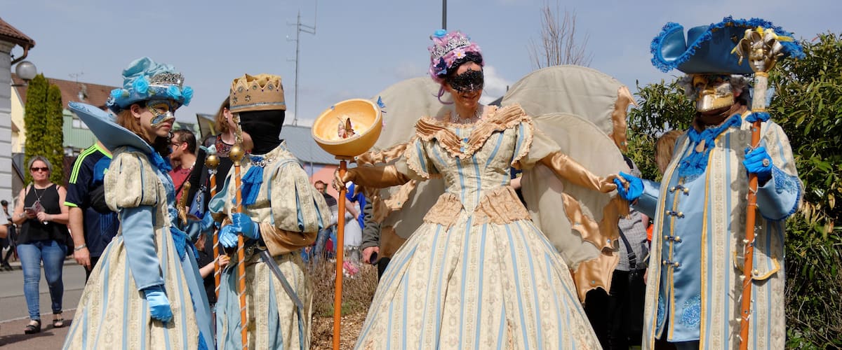 A group of people in historical costumes on a street.