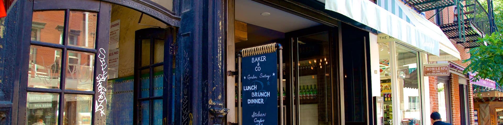 A storefront with a chalkboard menu advertising Italian cuisine, outdoor seating, and a brick facade.