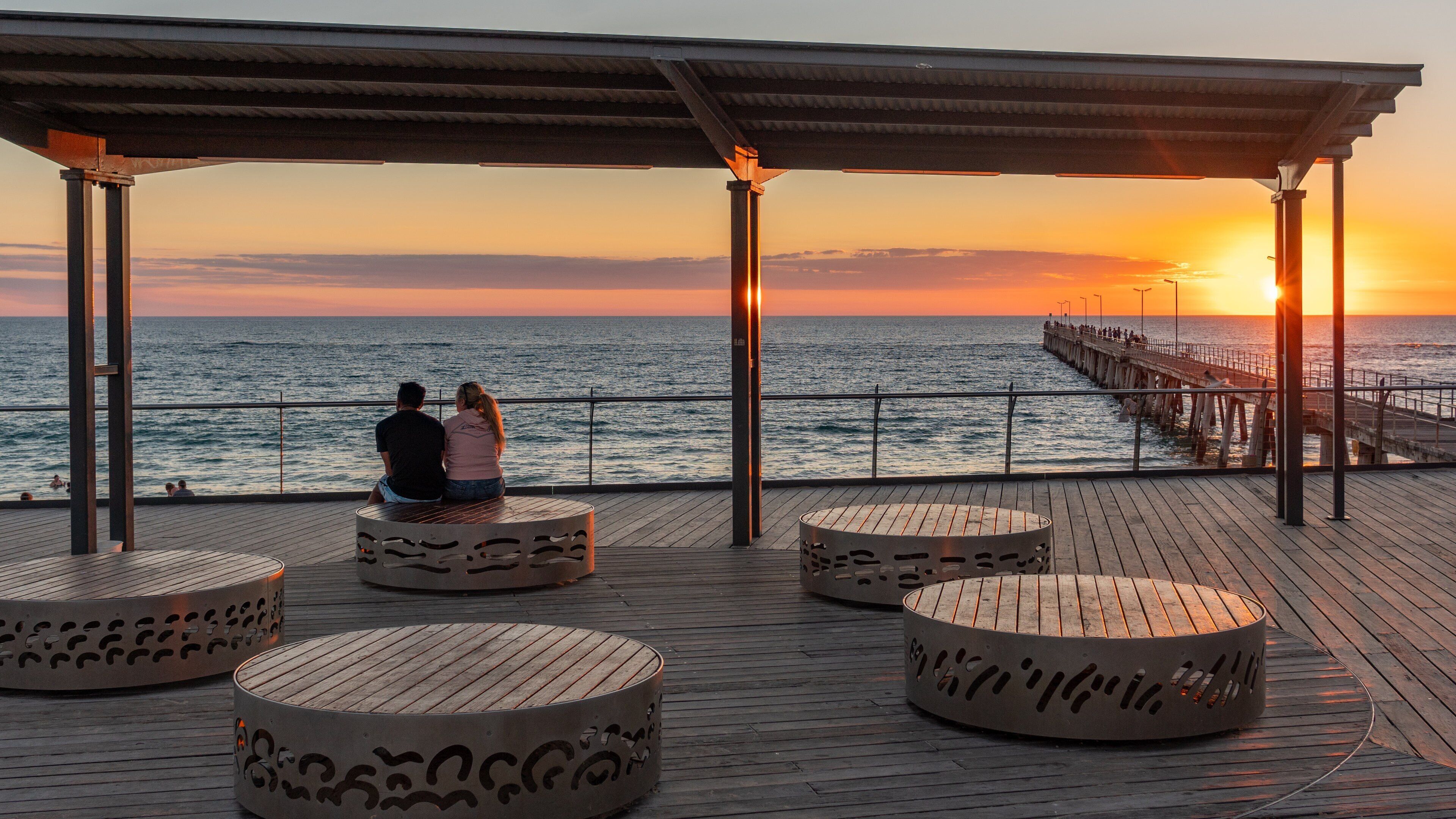 Port Noarlunga featuring a sunset and general coastal views as well as a couple