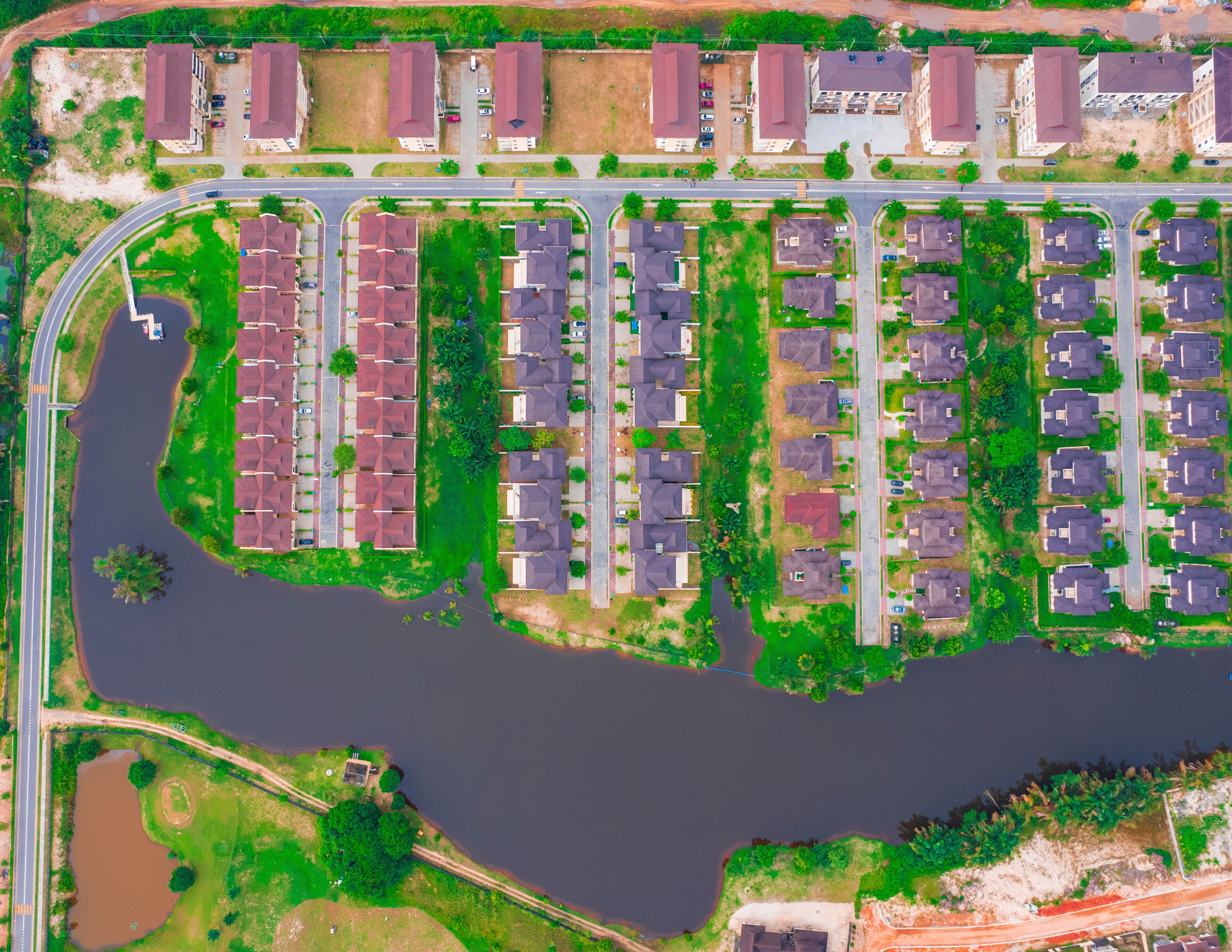 Aerial view of Lakowe Golf Estate with modern homes and a scenic lake surrounded by greenery, Lakowe, Nigeria.