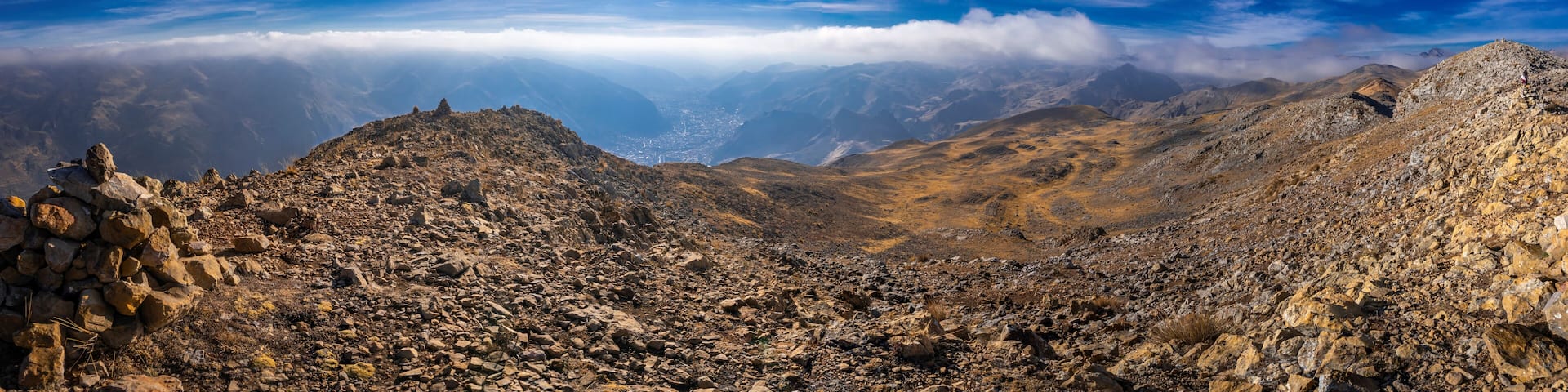 view of the city of huancavelica peru from a viewpoint on a sunny day with mist