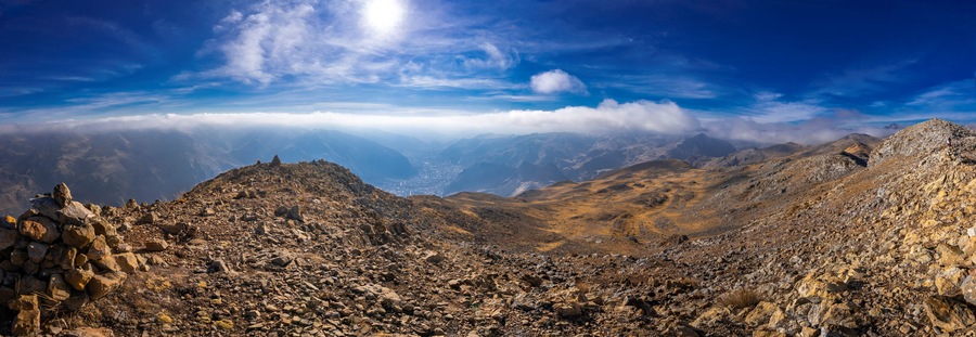 view of the city of huancavelica peru from a viewpoint on a sunny day with mist